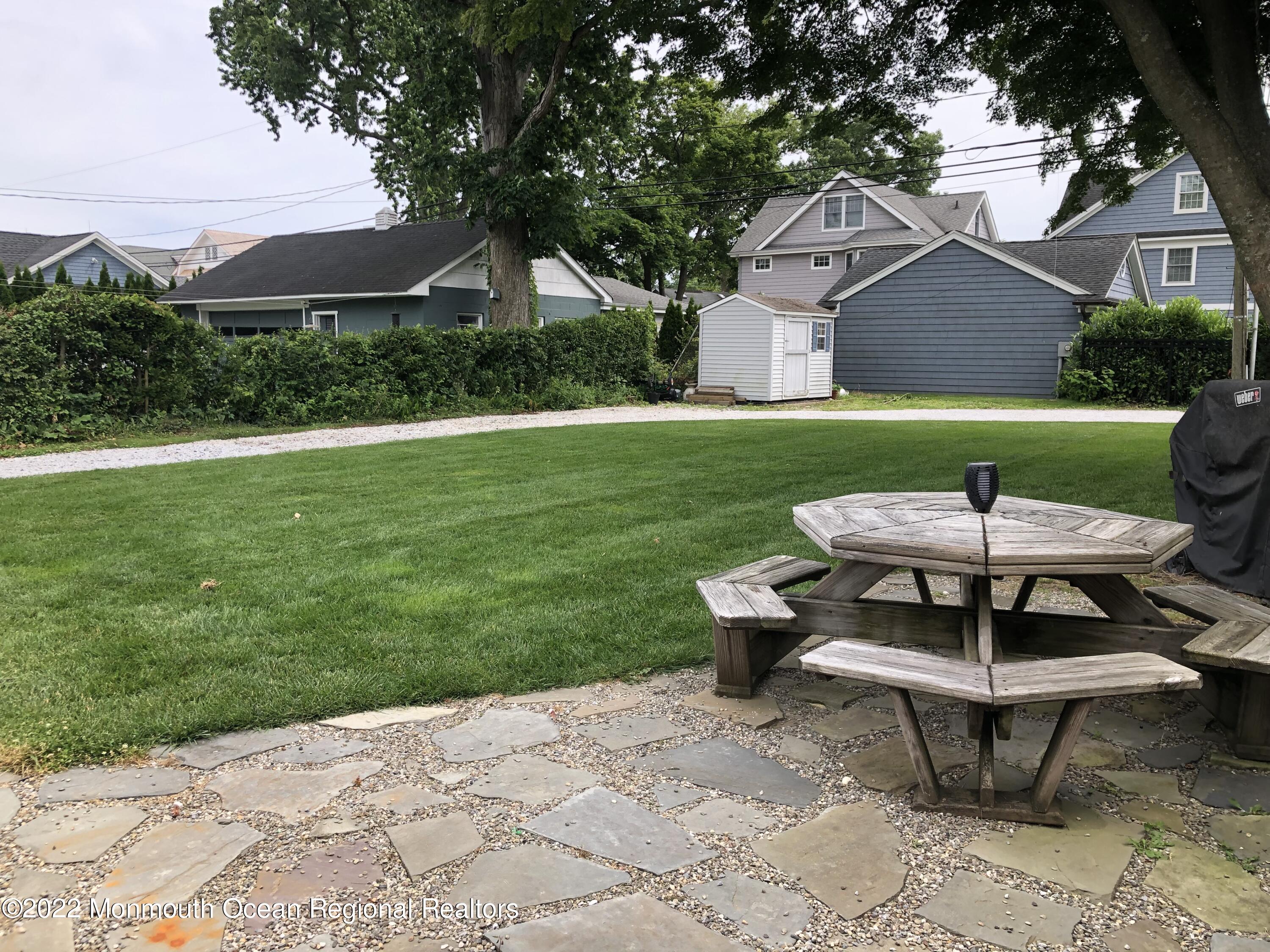 419 Jersey Avenue Spring Lake, NJ 07762 - Photo 26 of 32 a table and chairs in the garden