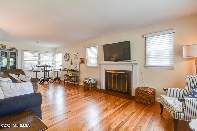 419 Jersey Avenue Spring Lake, NJ 07762 - Photo 30 of 32 a living room with furniture fireplace and a window
