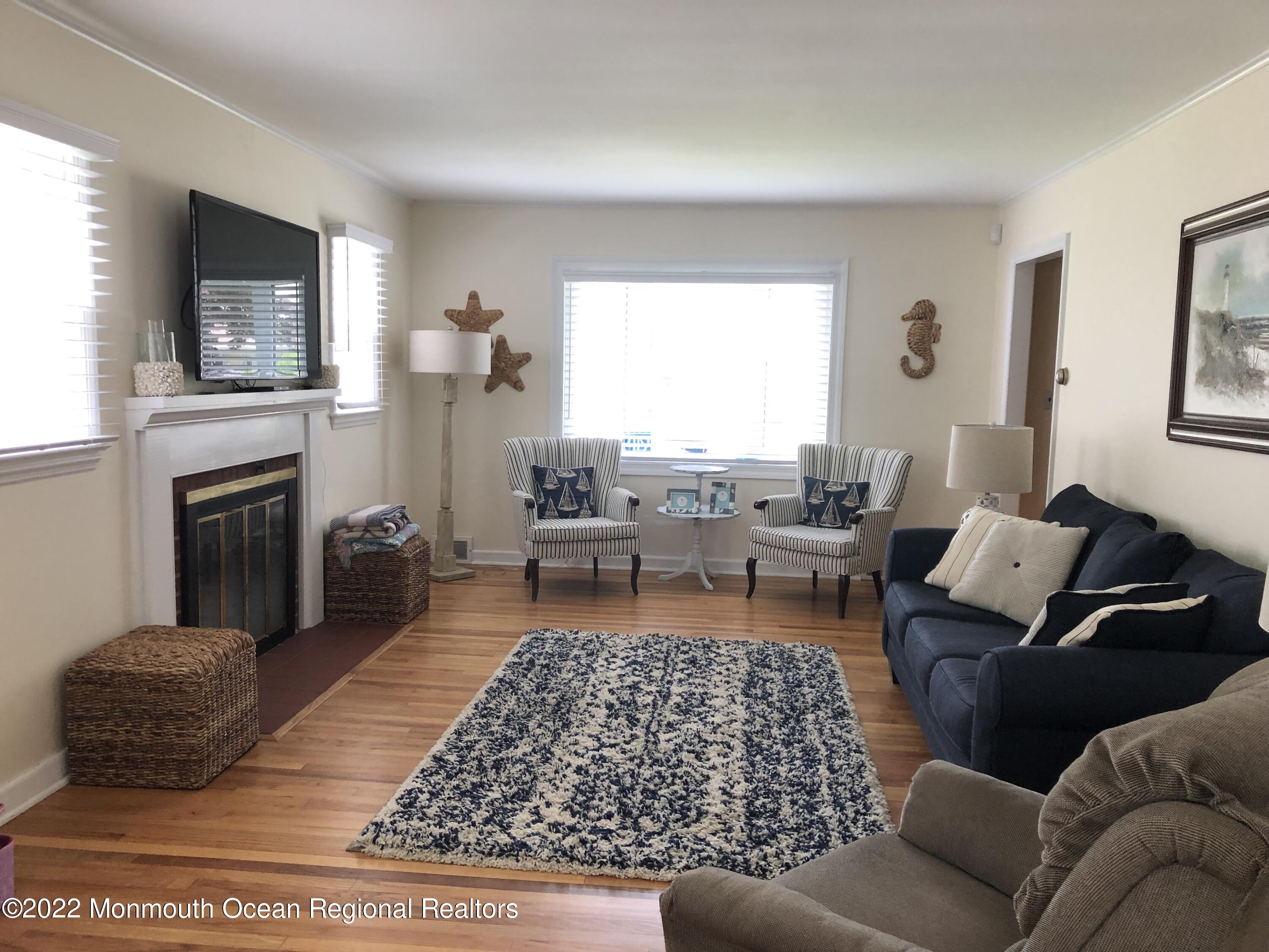 419 Jersey Avenue Spring Lake, NJ 07762 - Photo 7 of 32 a living room with furniture and a fireplace