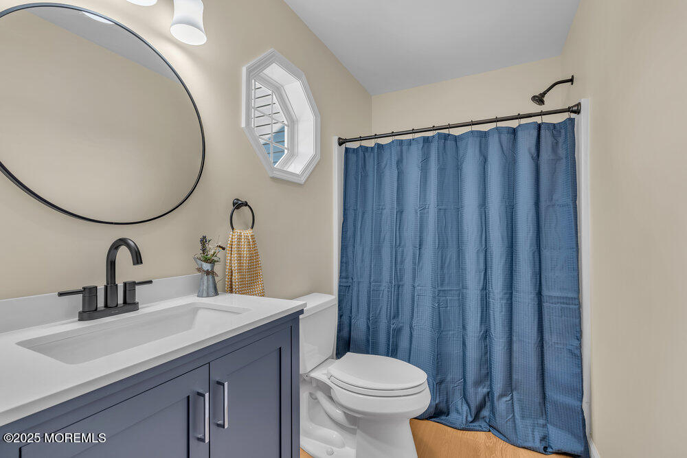 87 Maple Avenue Tuckerton, NJ 08087 - Photo 22 of 48 a bathroom with a sink a toilet and a mirror