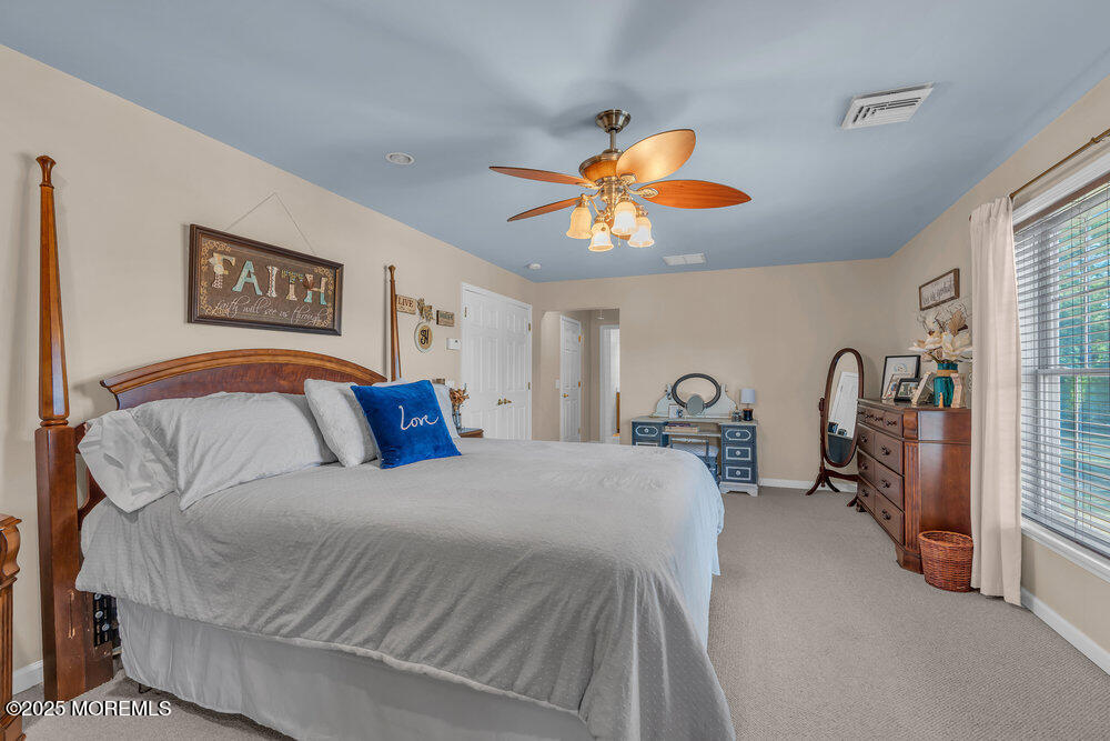87 Maple Avenue Tuckerton, NJ 08087 - Photo 33 of 48 a bedroom with a bed and a chandelier