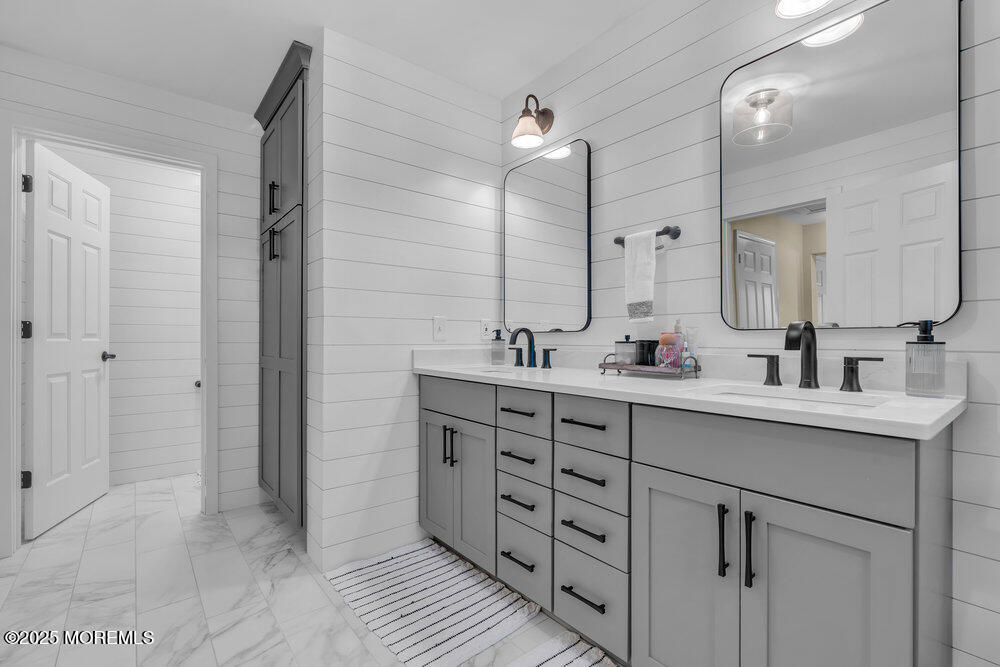 87 Maple Avenue Tuckerton, NJ 08087 - Photo 36 of 48 a bathroom with a double vanity sink a mirror and a shower