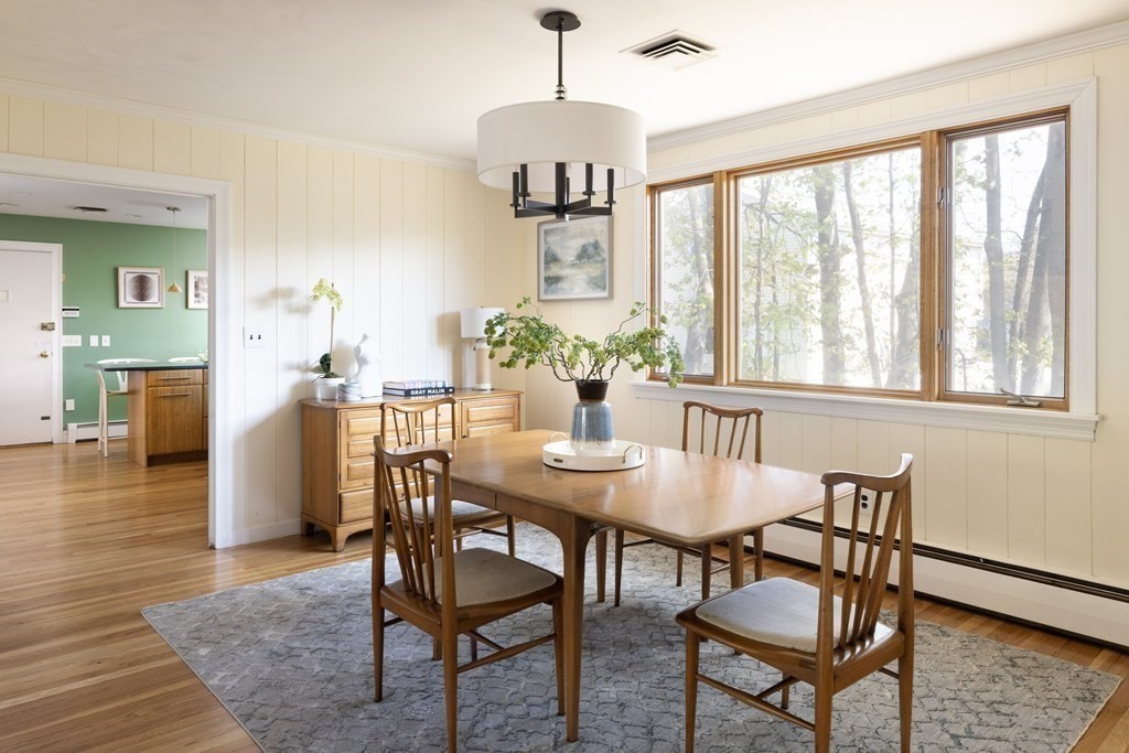 66 Roosevelt Road Newton, MA 02459 - Photo 4 of 17 a dining room with furniture a chandelier and wooden floor