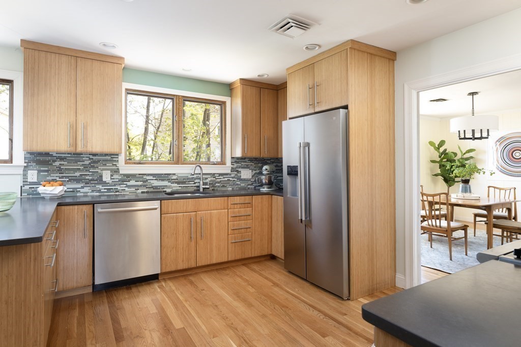 66 Roosevelt Road Newton, MA 02459 - Photo 6 of 17 a kitchen with stainless steel appliances granite countertop a refrigerator a sink and a granite counter tops with wooden floors