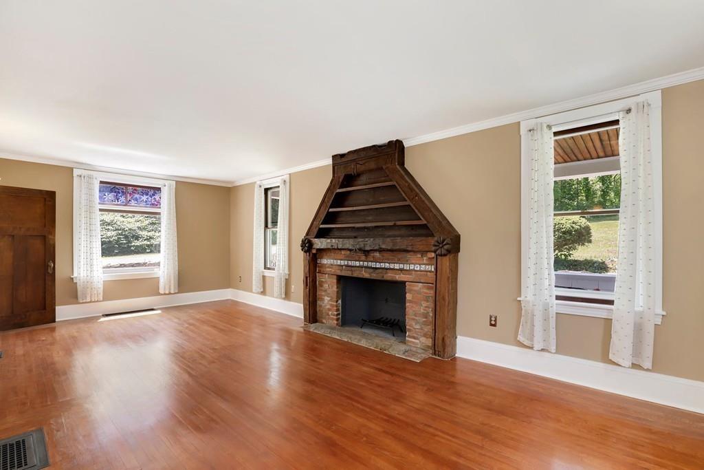 324 Turnpike Road Ashby, MA 01431 - Photo 13 of 41 an empty room with wooden floor fireplace and windows
