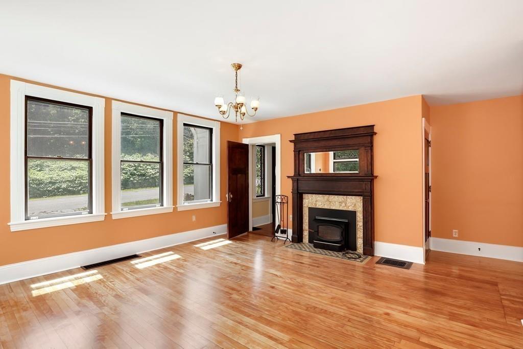324 Turnpike Road Ashby, MA 01431 - Photo 17 of 41 a view of an empty room with wooden floor fireplace and a window