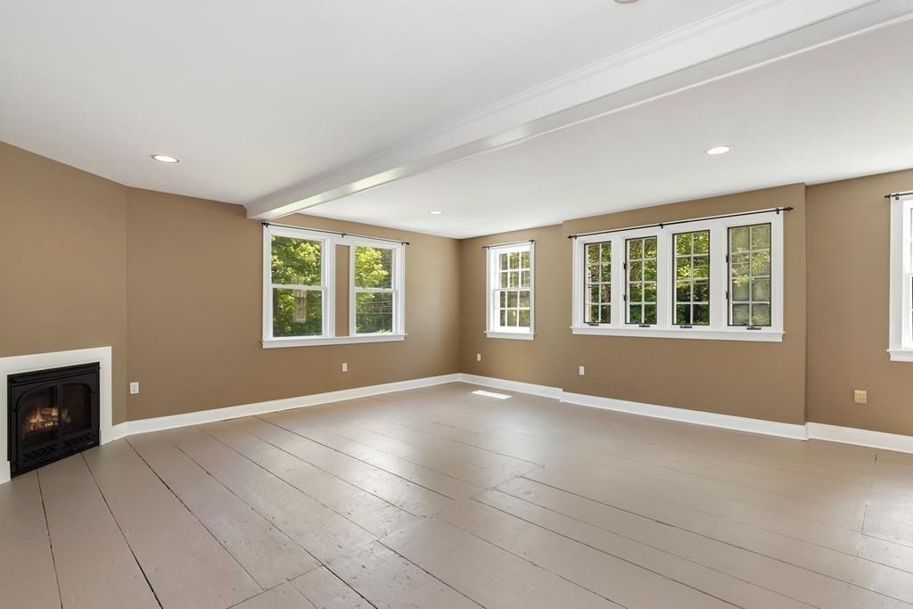 324 Turnpike Road Ashby, MA 01431 - Photo 22 of 41 an empty room with windows and fireplace