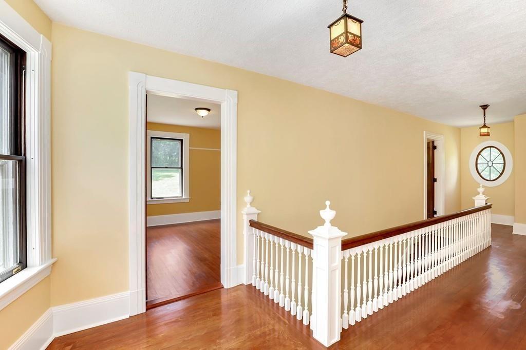 324 Turnpike Road Ashby, MA 01431 - Photo 26 of 41 a view of a hallway to a room with wooden floor and windows