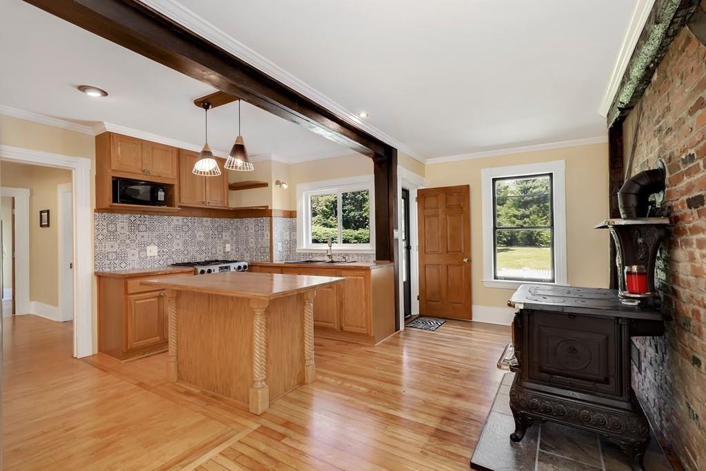 324 Turnpike Road Ashby, MA 01431 - Photo 7 of 41 a large kitchen with stainless steel appliances kitchen island granite countertop a refrigerator a stove a sink and dishwasher with wooden floor