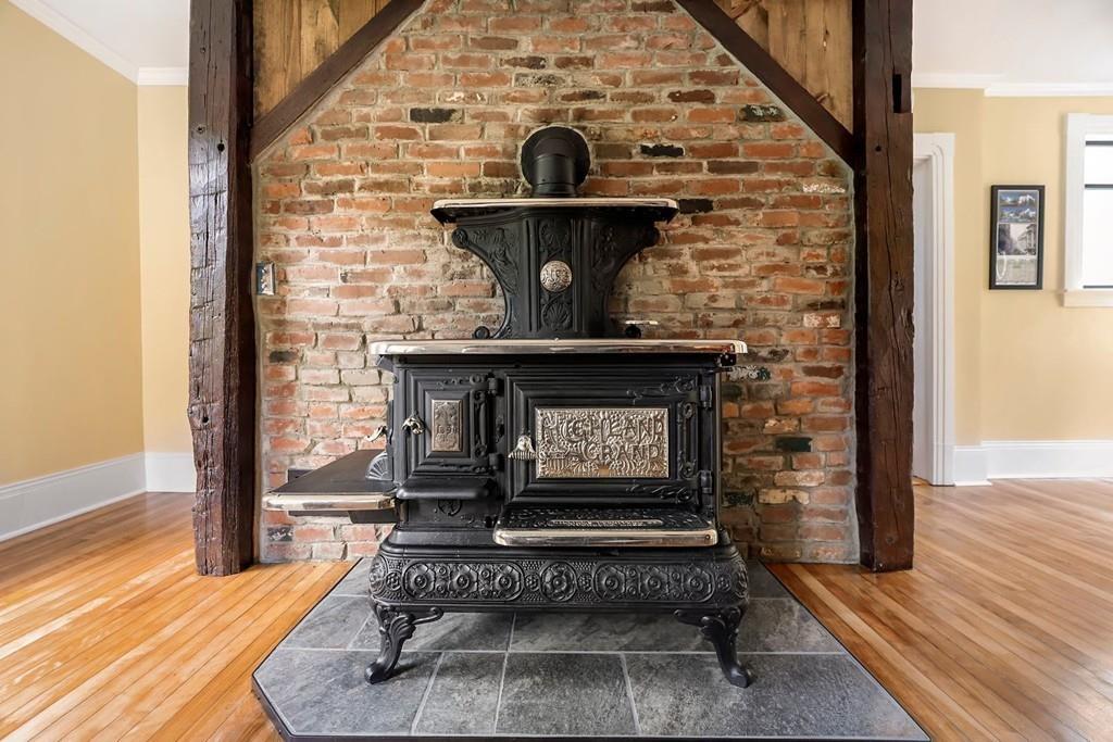 324 Turnpike Road Ashby, MA 01431 - Photo 10 of 41 a living room with a fireplace windows and wooden floor