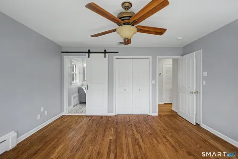 a view of empty room with wooden floor