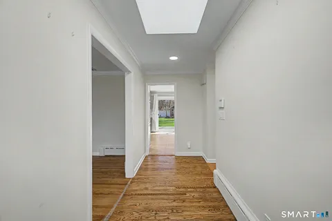 a view of a hallway with wooden floor
