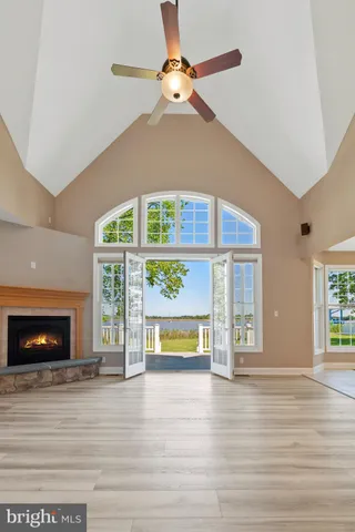 a view of an empty room with a fireplace and a window