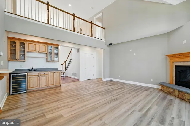 a view of an empty room with window and fireplace