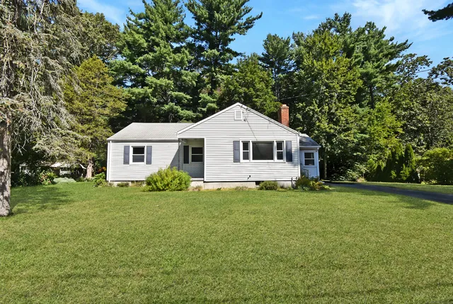 a view of a house and a yard with green space