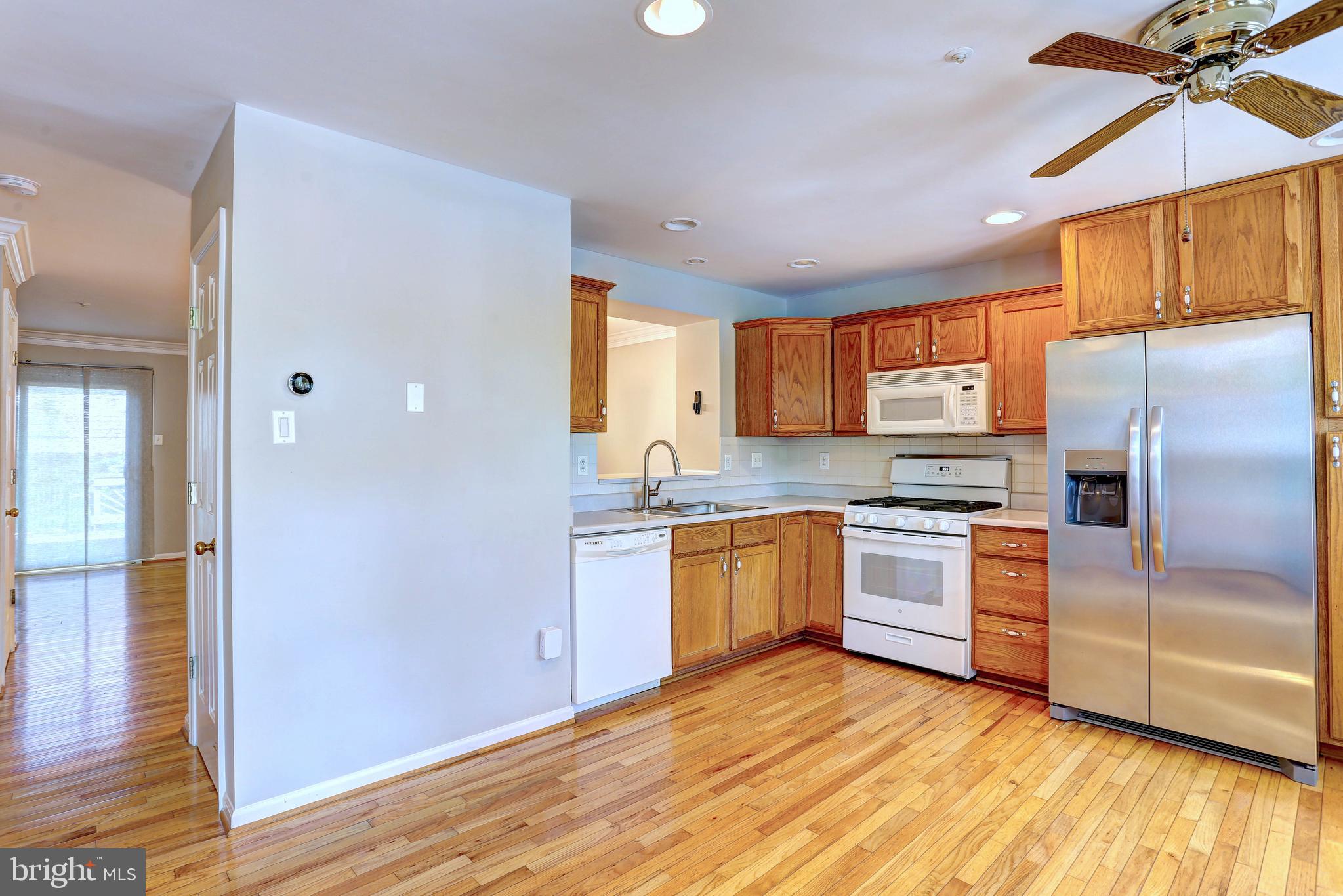 6136 Starburn Path Columbia, MD 21045 - Photo 2 of 35 a kitchen with granite countertop a refrigerator and a sink
