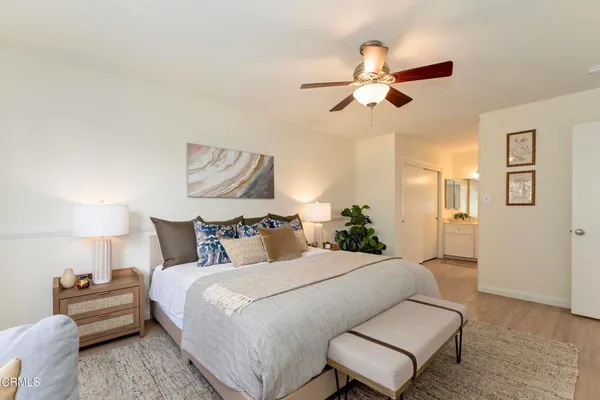 a bedroom with a bed furniture and a lamp