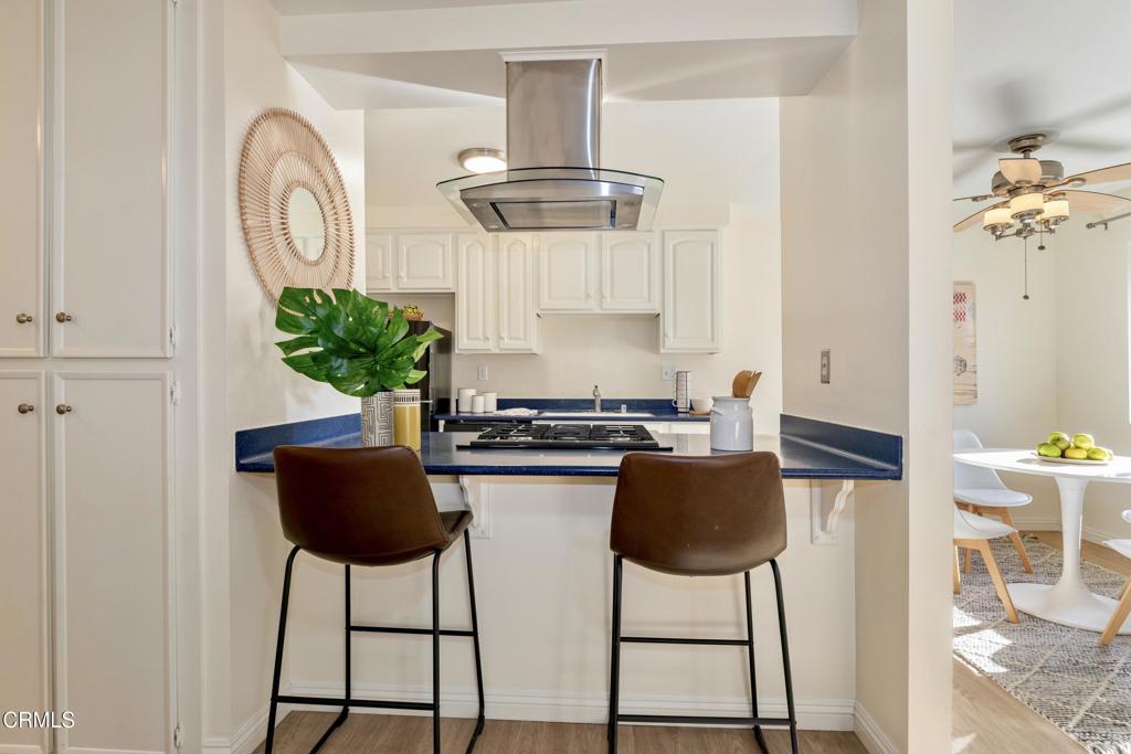 5436 McCulloch Avenue, Unit F Temple City, CA 91780 - Photo 10 of 33 a kitchen with stainless steel appliances granite countertop a stove a chimney a sink and a dining table