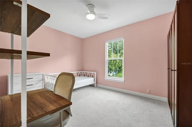 a view of a room with furniture and a window