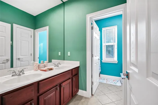 a bathroom with a double vanity sink and a mirror