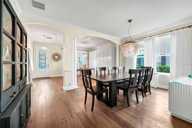 a view of a dining room with furniture window and wooden floor