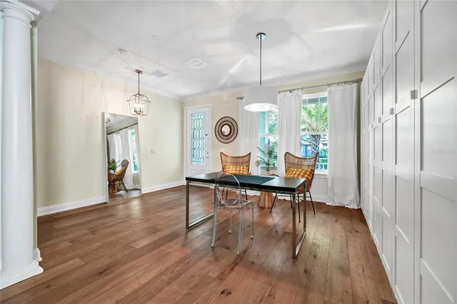 a view of a dining room with furniture window and wooden floor