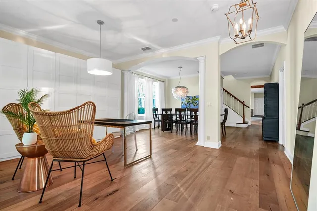 a view of a dining room with furniture and wooden floor