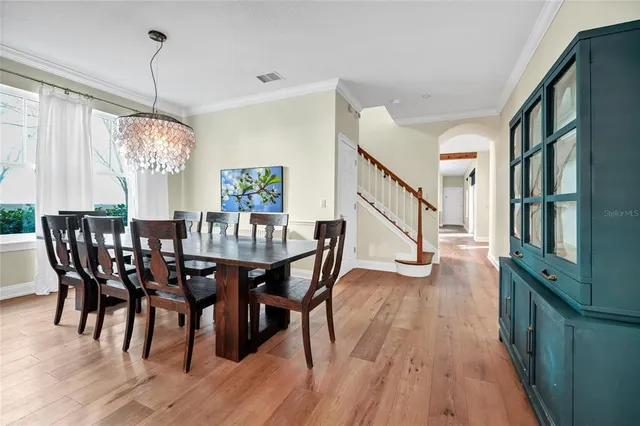 a view of a dining room with furniture window and wooden floor