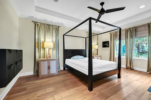 a bedroom with a bed window and a flat tv screen