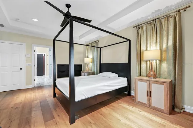 a bedroom with a bed lamp and a window