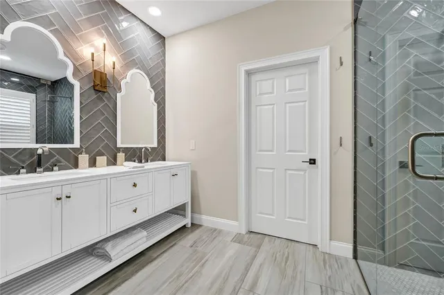 a spacious bathroom with a double vanity sink and a mirror