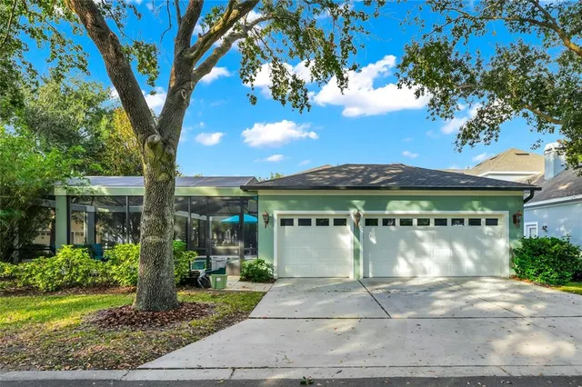 a front view of a house with a yard and potted plants