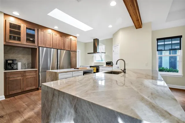 a kitchen with sink refrigerator and microwave