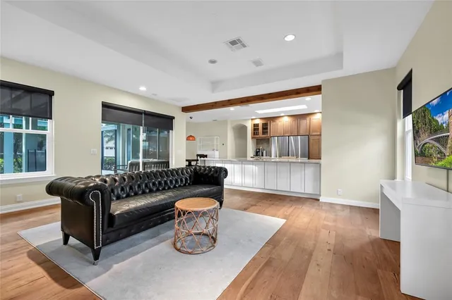 a living room with furniture and a wooden floor