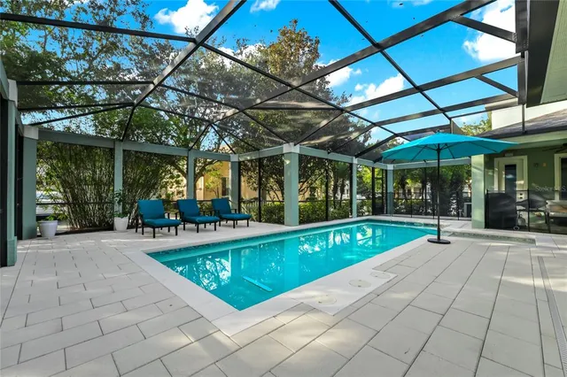 a view of a patio with a table and chairs under an umbrella
