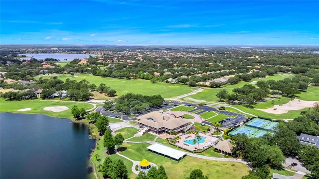 an aerial view of a city with lots of residential buildings ocean and mountain view in back