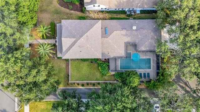 an aerial view of a house with a garden and a yard