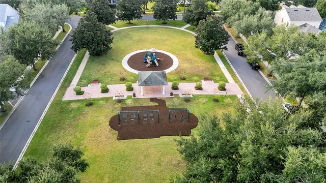 an aerial view of a residential houses with yard and swimming pool