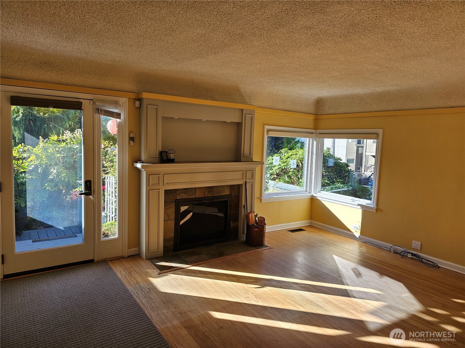 2822 Prosch Avenue West Seattle, WA 98119 - Photo 11 of 31 a living room with a fireplace windows and a table