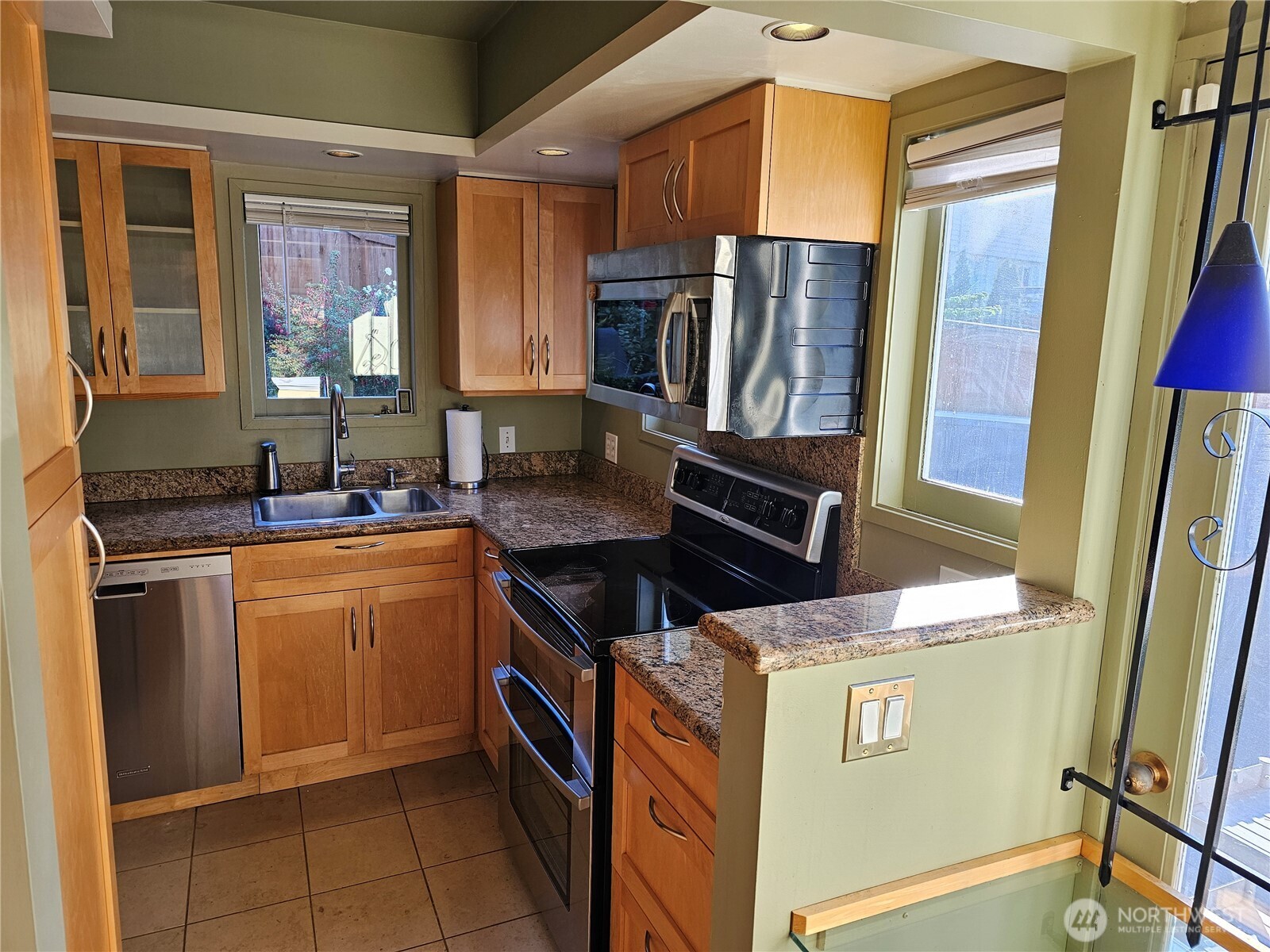 2822 Prosch Avenue West Seattle, WA 98119 - Photo 16 of 31 a kitchen with stainless steel appliances granite countertop a stove a refrigerator and a sink