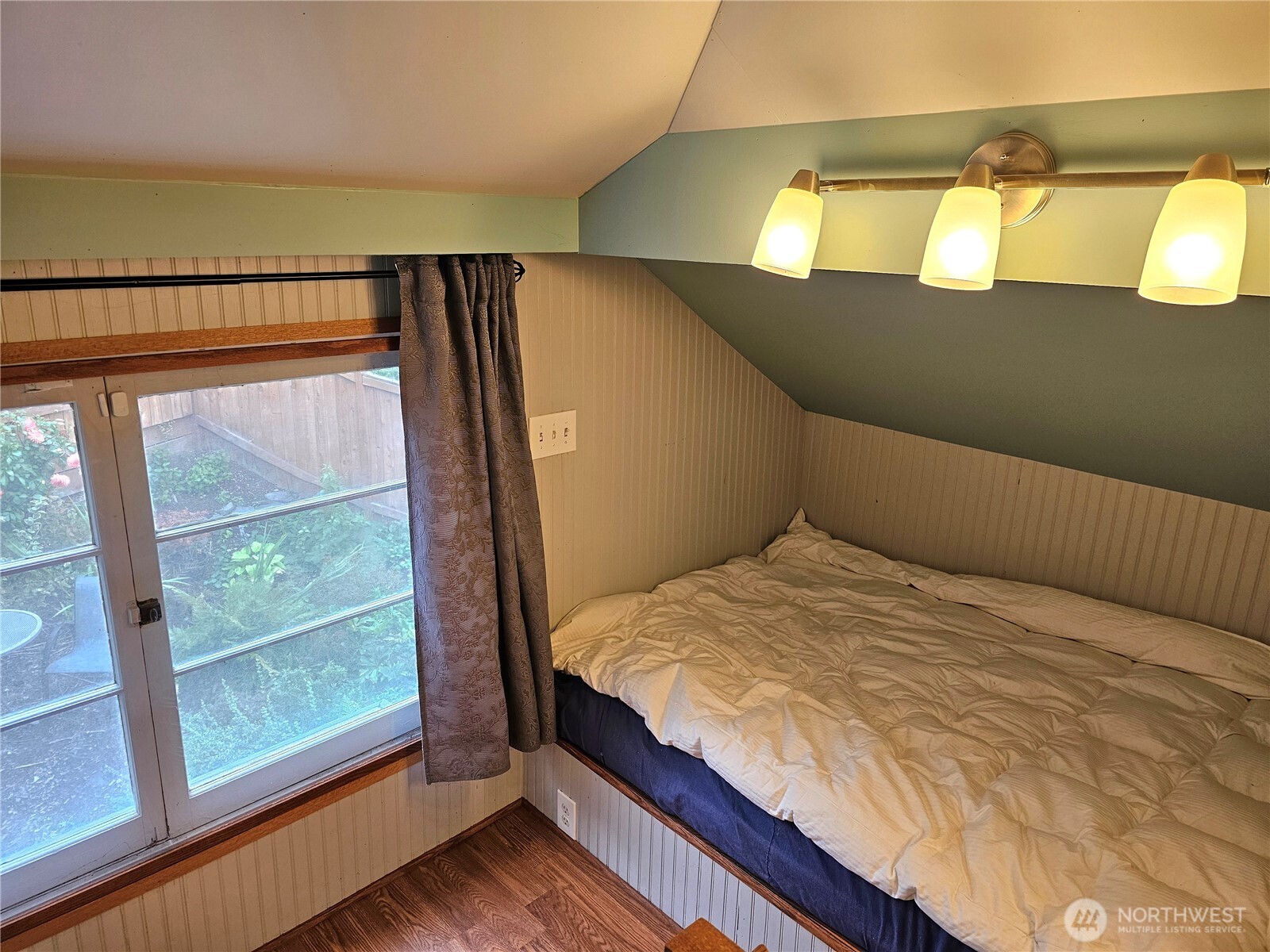 2822 Prosch Avenue West Seattle, WA 98119 - Photo 29 of 31 a bedroom with a bed and wooden floor