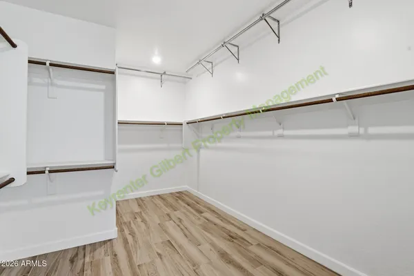 a kitchen with a sink a refrigerator and wooden floor