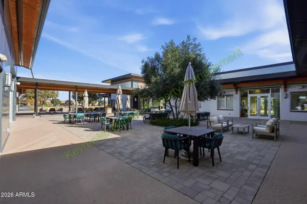 a view of a patio with a table and chairs