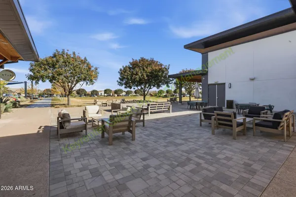 a view of a patio with a table and chairs under an umbrella