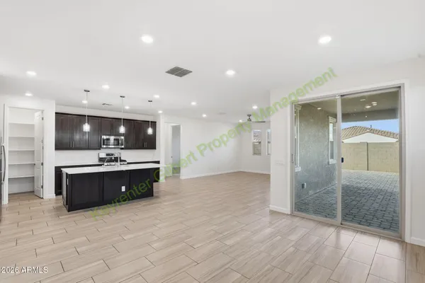 a kitchen with stainless steel appliances a refrigerator and a microwave