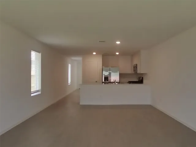 a view of kitchen and kitchen with stainless steel appliances