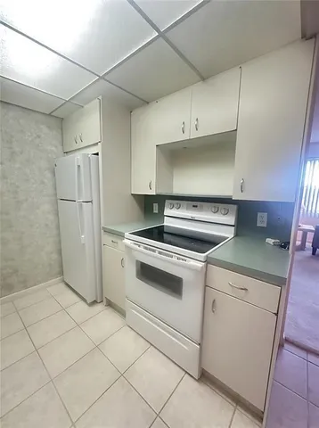 a kitchen with cabinets and white appliances