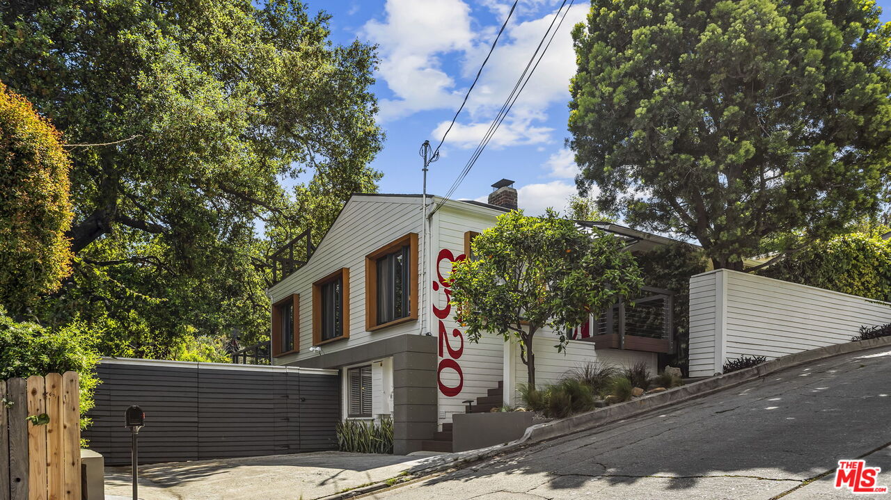 a front view of a house with tree s