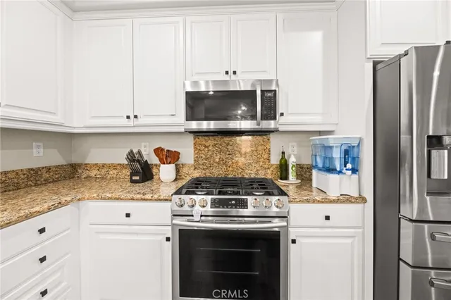 a kitchen with kitchen island a counter top space and cabinets