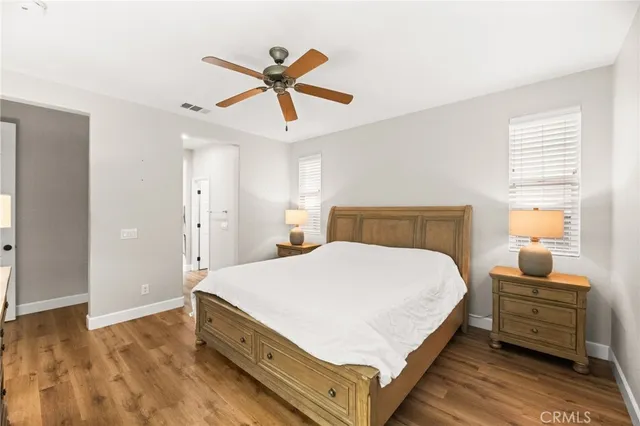 a bed room with a bed and a ceiling fan